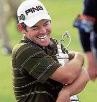 ITS MINE: South Africa's Louis Oosthuizen hugs the Claret Jug after winning the British Open golf championship at St Andrews on Sunday. AP