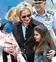 US Secretary of State Hillary Clinton is greeted by  a student at Roots School in Rawalpindi in Islamabad on Sunday. AP