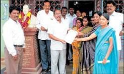 MLA K P Bachegowda giving away cheques under Dr B R Ambedkar Development Corporations small loan scheme to members of Arundhati Self Help Group in Chikkaballapur on Sunday. DH Photo