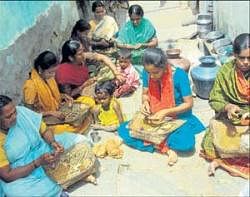 Life goes on: Women rolling beedis in Noor Nagar in Kolar. DH Photo