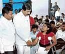 all the best: Labour Minister N Bachegowda greets a girl at skill and job fair for differently-abled in Bangalore on Sunday. Labour Department Secretary Ramesh B Zalaki and Corporator Mahesh Babu are seen.  DH Photo