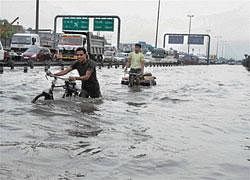 Damned highway: A view of the water-logged National Highway 8 after rain lashed Gurgaon on Tuesday. PTI