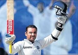 Lone hand: Virender Sehwag acknowledges the crowd after reaching his century on the fourth day of the first Test against Sri Lanka on Wednesday. AFP