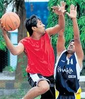 ROCK SOLID: Kanakas Girish tries to thwart Supradeep of BEML in the State B Division basketball championship in Bangalore on Wednesday.DH PHOTO