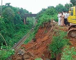 The spot being cleared off where hillock developed cracks, near  Konkan railway track at Kulai, on Thursday. dh photo