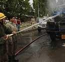 Firefighters extinguish a government vehicle after it was set on fire by Kashmiri protesters in Srinagar, India. AP