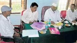 CATERING TO CATTLE: Animal Husbandry Minister Revu Naik Belamagi at a meeting to review the progress of the Department in Chikkaballapur on Friday. Deputy Director Shivaram and others are seen. DH Photo