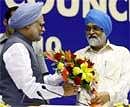 Prime Minister Manmohan Singh being welcomed by Deputy Chairman of Planning Commission Montek Singh Ahluwalia at the 55th meeting of National Development Council at Vigyan Bhavan in New Delhi on Saturday. PTI