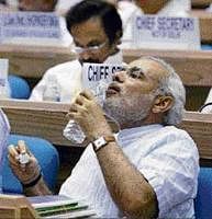 Gujarat Chief Minister Narendra Modi drinks water at the 55th meeting of the National Development Council at Vigyan Bhavan in New Delhi on Saturday. PTI