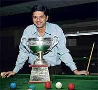 Gritty Win: IH Manudev paints a happy picture with his State-ranking snooker tournament trophy at the KSBA Hall on Saturday. DH Photo