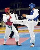 Strong Blow: Karnatakas BS Rajesh (right) lands a kick on SAIs Arun R en route to claiming the 51kg gold in the South Zone taekwondo championships on Saturday. DH Photo
