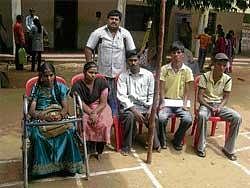 Will and Way: Physically-challenged waiting for their turn at the job fair in Chikkaballapur on Saturday. DH Photo