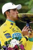 Its Mine To Keep: Astana rider Alberto Contador kisses the Tour de France trophy on Sunday. AFP