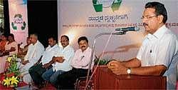 District-in-Charge Minister J Krishna Palemar adrressing the gathering after the inauguration of waste management theme oriented contests organised for school and college students in Mangalore on Sunday.  MCC Commissioner Dr K N Vijay Prakash looks on. DH Photo