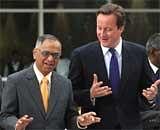 Chief Mentor of Infosys Technologies NR Narayana Murthy (left)  welcomes British Prime Minister David Cameron to The Infosys Campus in Bangalore on Wednesday.AFP