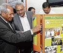 quick click: Krishi Mission Chairman Dr S A Patil inaugurating the instant ragi malt vending machine at Hebbal Bakery Training Unit on Tuesday. UAS Vice-Chancellor Dr K Narayana  Gowda, Board members Athihalli Devraju and D V Ramesh are also seen. dh Photo