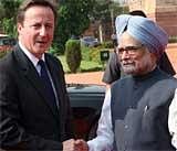 British Prime Minister David Cameron shakes hands with his Indian counterpart Manmohan Singh during his ceremonial reception at the Rashtrapati Bhavan in New Delhi on Thursday. PTI