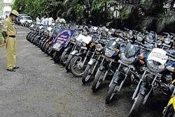 A cop looks at recovered bikes in Bangalore. DH file photo