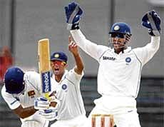 Howzzat? MS Dhoni and Rahul Dravid successfully appeal for an LBW decision against Mahela Jayawardene. AFP