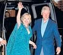 US Secretary of State Hillary Clinton waves beside her husband former president Bill Clinton as they arrive for an after-party for their daughter Chelsea in New York on Friday.