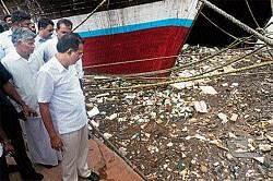 Minister for Ports and Inland Water Transport Krishna J Palemar having a look at the sewage and waste dumped at Old port during the inspection the jetty construction , in Mangalore on Tuesday. DH Photo