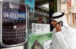 A man walks past a sign advertising the BlackBerry mobile phone at a shopping mall in Dubai as the Gulf business hub stated it will suspend key BlackBerry services from October because they are incompatible with local laws and raise security concerns. AFP