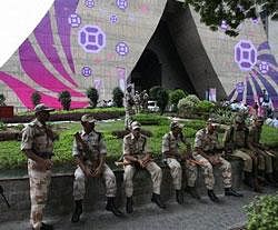 Security men guarding at the CWG Organising Committee headquarters during a protest by Citizen Forum for Commonwealth Games in New Delhi. PTI