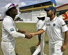 Sri Lanka captain Kumar Sangakkara, left, congratulates India's captain Mahendra Singh Dhoni after India defeated Sri Lanka in the third and final test cricket match in Colombo, Sri Lanka on Saturday.AP