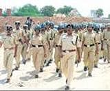 Security forces assigned to the Congress rally flag march in  Bellary on Sunday.  DH Photo