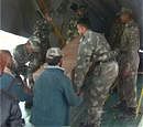 A body of a flash flood victim being loaded in a plane at Leh on Monday. PTI