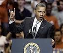 President Barack Obama gives a "hook 'em horns" sign as he starts a speech at Gregory Gym at the University of Texas in Austin, Texas on Monday. AP Photo