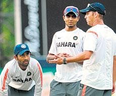 Painful blow: Dinesh Kaarthicks (left) thumb injury has only increased coach Gary Kirstens (right) headache as India struggle to fight their way back in the tri-series. AFP
