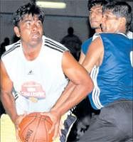Intense battle: KSP Trailblazers SC Mahesh (left) tries to get past Southern Blues Naveen in the NBA Challenge league basketball tournament in Bangalore on Sunday. DH Photo