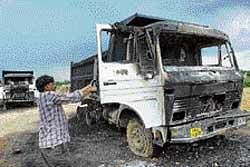 A villager trying to damage a truck during a demonstration demanding higher compensation for their land acquired for development of Yamuna Expressway in Mathura on Sunday. PTI