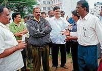 Heated discussion taking place between Malnad Educational Committee member Manjunath and Principal of Government Pre- University College Nagaraj in Hassan on Monday, when the latter went to start construction work on a disputed land.  dh photo