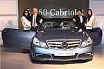Wilfried Aulbur (2nd L), MD and CEO of Mercedes-Benz India and Debasis Mitra Director-Sales and Marketing, along with models posing with the new E-Class Cabriolet during its launch in New Delhi on Tuesday. PTI