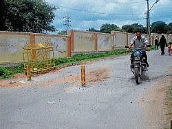Two metal posts installed on N R Link road where a lorry mowed two kids to death in Mysore on Monday. dh photo