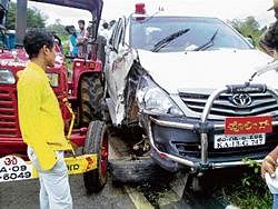 The damaged car belonging to SP and the tractor at the accident site on Hunsur Road near Yelwal on Wednesday. DH Photo