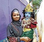 A woman taking her child to Srikrishnarjuna Fancy Dress Competition in Shidlaghatta on Wednesday. DH PHOTO
