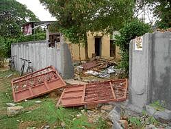 The compound wall of the house of a worker that the BGML security guards brought down, in the Italian Block of Marikuppam, Kolar Gold Fields, on Wednesday. DH PHOTO