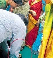 Tourism Minister Janardhana Reddy picks up Sushma Swarajs sandals.