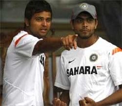 Indian cricketers Suresh Raina (left) and Ravindra Jadeja look on as their practice session is interrupted due to rain in Dambulla on Saturday. AP