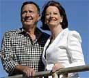 Australian Prime Minister Julia Gillard (right) with her partner Tim Mathieson in Melbourne on Sunday. AP