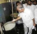 Whats Cooking? Chief Minister B S Yeddyurappa doing a quality check of the food in the kitchen of the Beggars Colony in Bangalore on Saturday. DH Photo