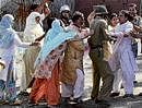 A security person scuffles with a woman protester during a demonstration in Srinagar on Saturday. PTI