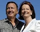Australian Prime Minister Julia Gillard, right, leader of the Australian Labor Party, smiles with her partner Tim Mathieson at her hometown of Altona in Melbourne, Australia, Sunday, Aug. 22, 2010. It could take more than a week to learn who will govern Australia after a cliffhanger election, the closest in nearly 50 years, and the winner may have to woo the support of a handful of independent lawmakers in order to assume power. AP