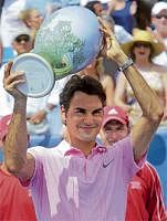 Delighted: Roger Federer holds aloft the Cincinnati Masters trophy after defeating Mardy Fish on Sunday. AP