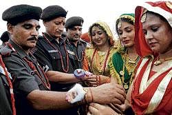 sealing a bond: College girls tie rakhi on  the wrists of jawans during Raksha Bandhan festival at Khasa, Punjab, on Tuesday. AFP