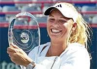 Sparkling smile: Denmarks Caroline Wozniacki celebrates with the Montreal Cup on Monday. Wozniacki defeated Russias Vera Zvonereva 6-3, 6-2 in the final. AP