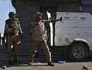 An Indian paramilitary soldier uses a sling against Kashmiri protesters during a clash between Kashmiri protesters and Indian police and paramilitary soldiers in Srinagar. AP